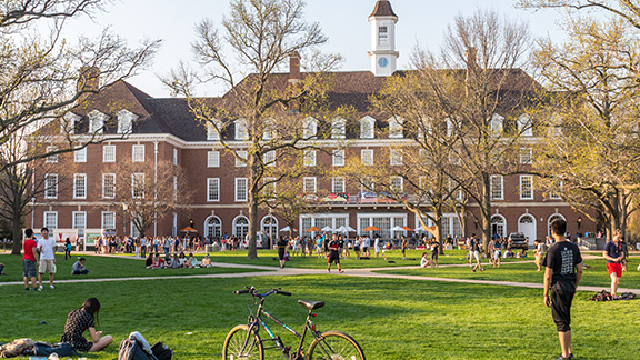 A man walking in the park near college