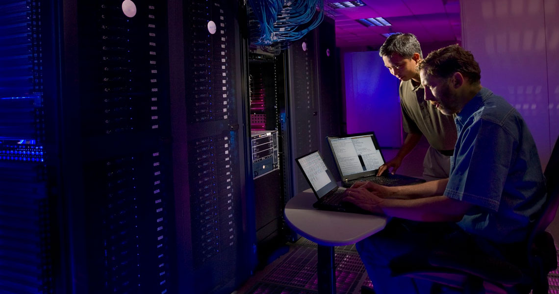 Two guys working in a server room