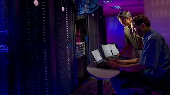 Two guys working in a server room